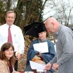 Philip Duer and Ellen McClanahan, left, check in visitors to the Shy's Hill Memorial