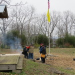 Reeanctors warm by campfire and chat with visitors