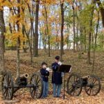 Andy VanDeVoort and granddaughter Violet Filipiak sound Taps